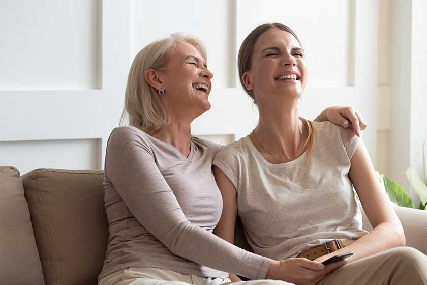 middle age woman and daughter laughing