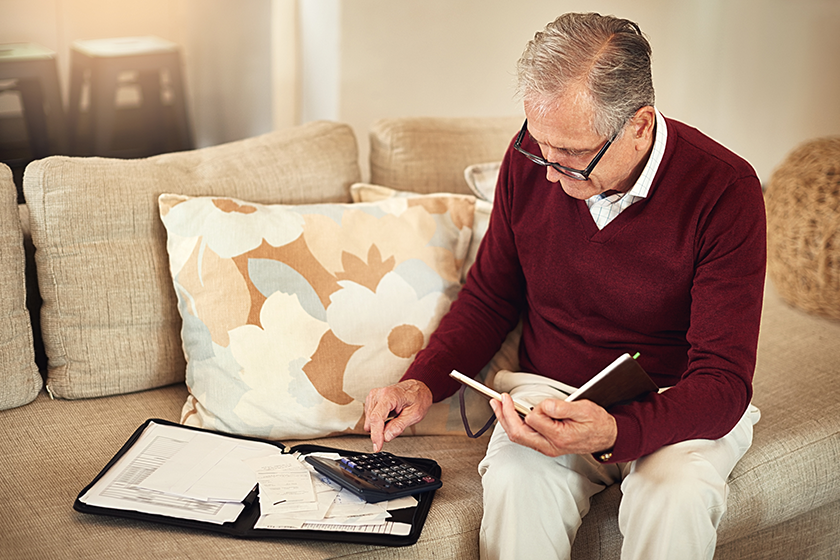 middle age man using calculator
